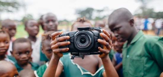 Canva - Children Standing and One Person Holding Camera